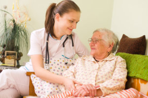 nurse assisting an old woman